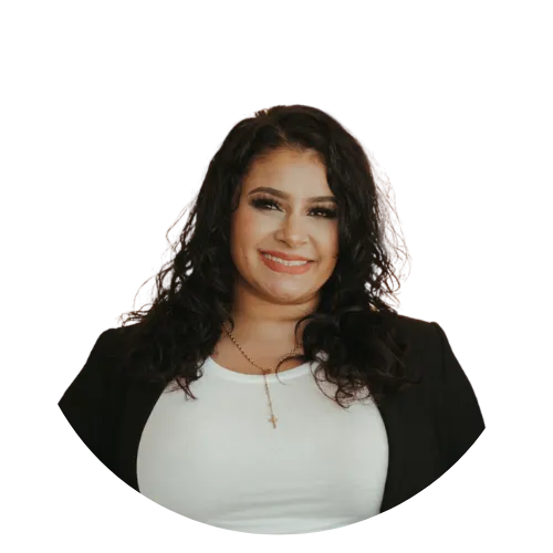 Portrait of a woman with dark hair, wearing a white top, hoop earrings, and smiling against a white background.