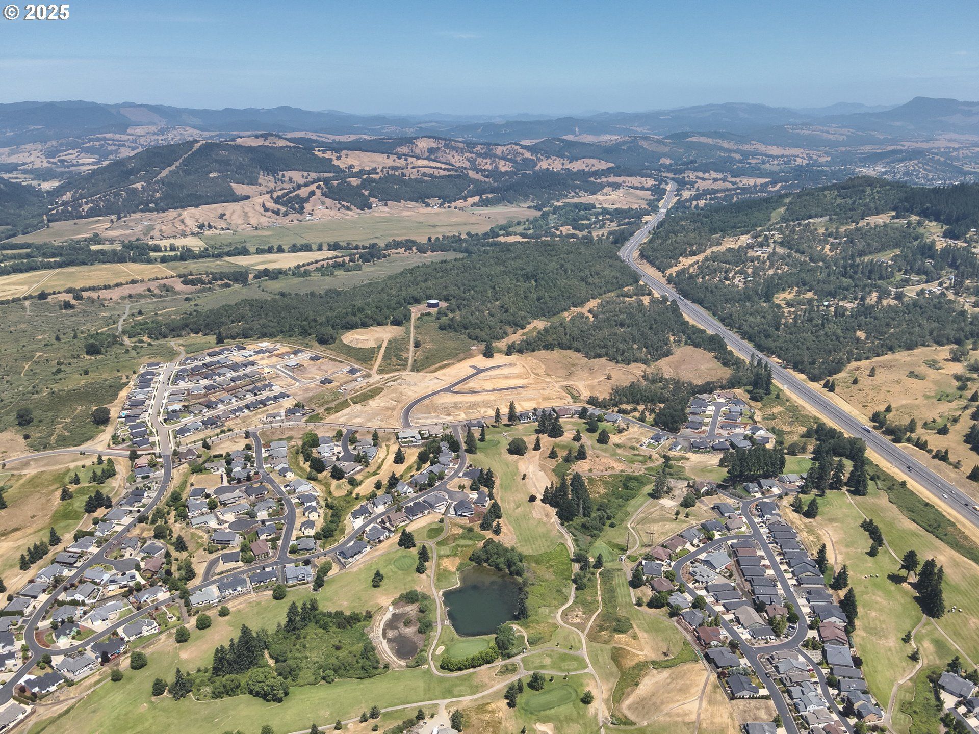 bay with boats in it and town in background