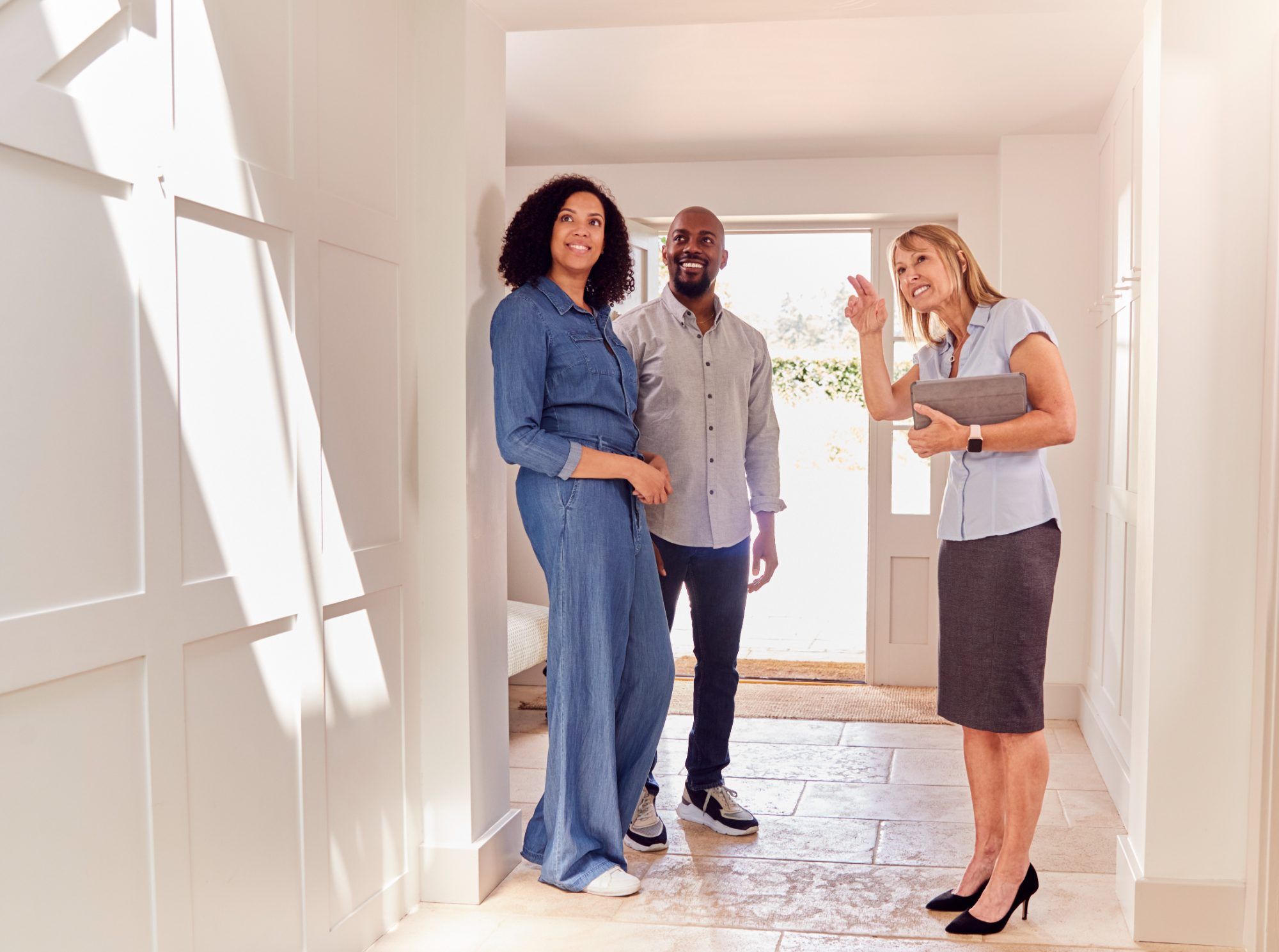Couple touring a home with their real estate agent