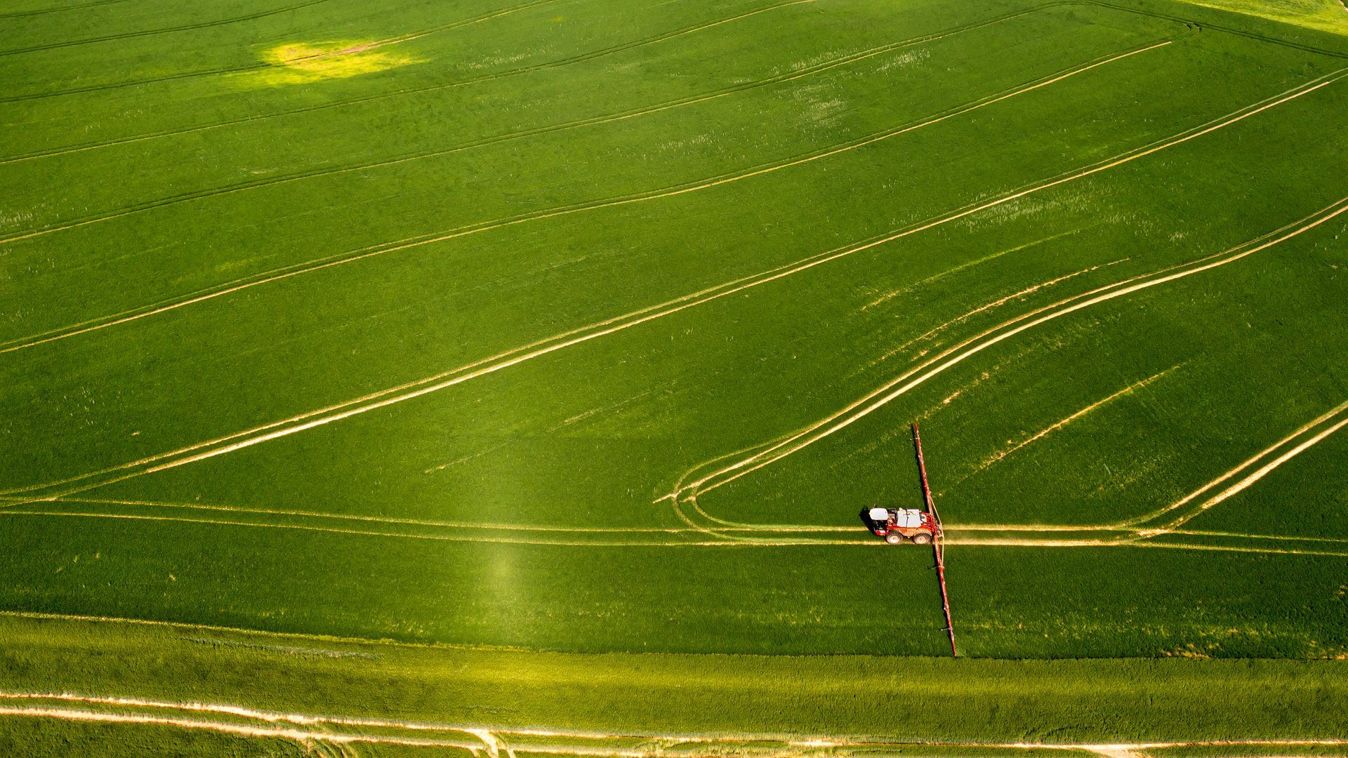 Tractor working a farm field, representative of Gem County, Idaho's agricultural land.