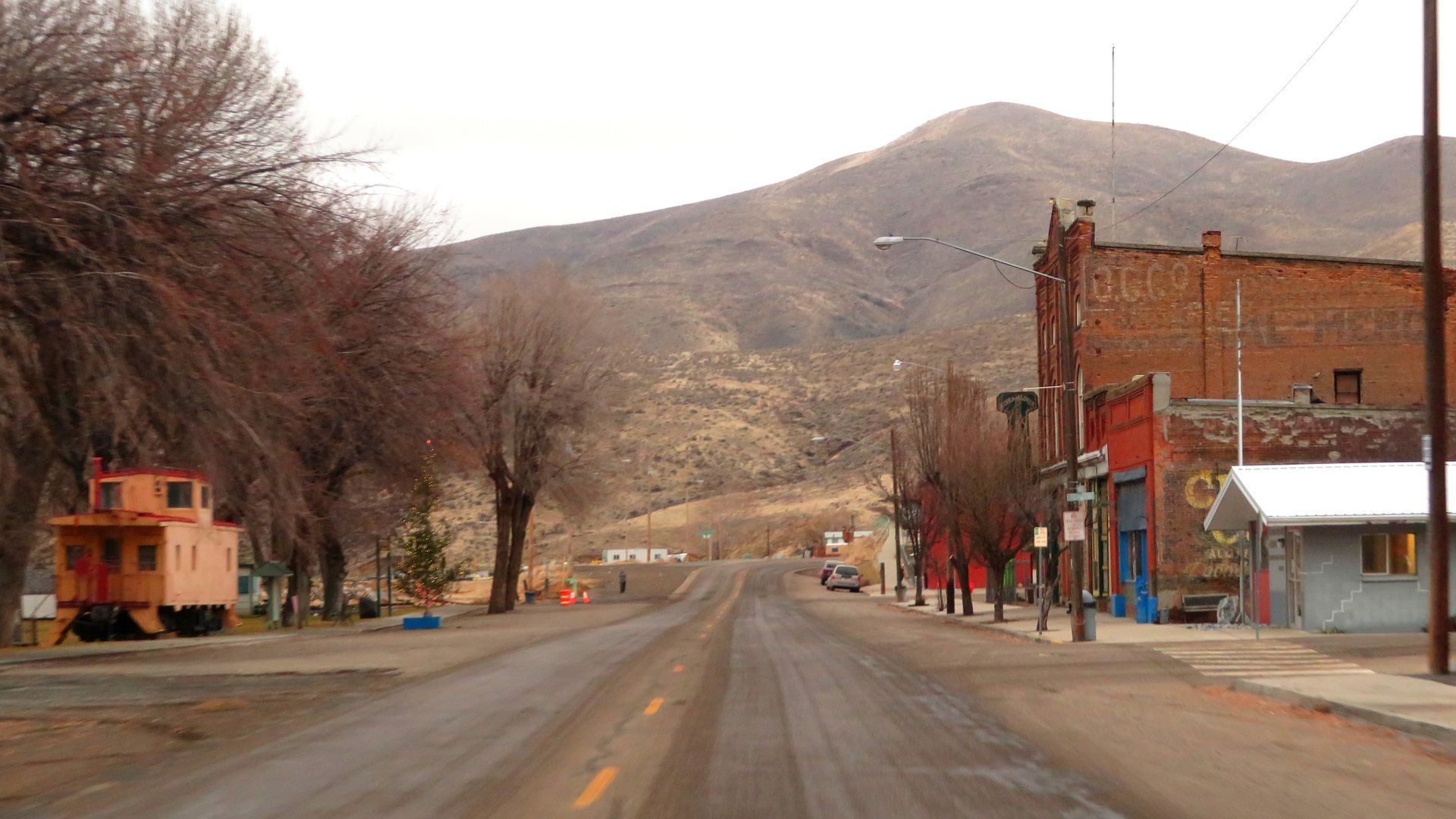Main street view of Huntington, Oregon with surrounding hills.