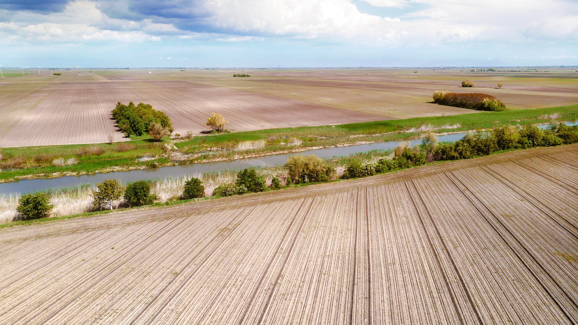 Aerial view of farmland along a river, representative of Payette County, Idaho's agricultural landscape.