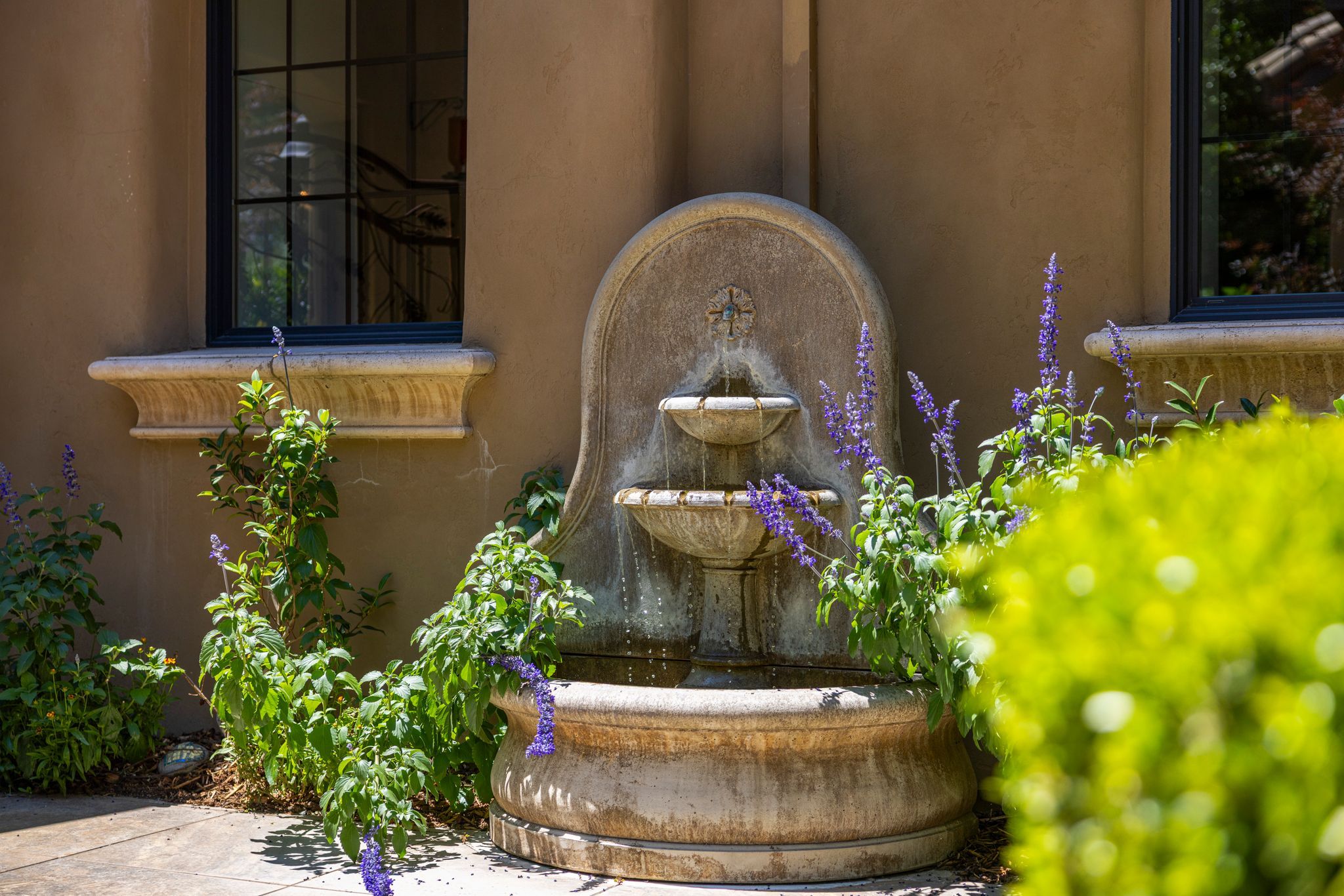 Luxury home courtyard fountain with purple salvia — El Dorado Hills real estate — Yoffie Real Estate Group
