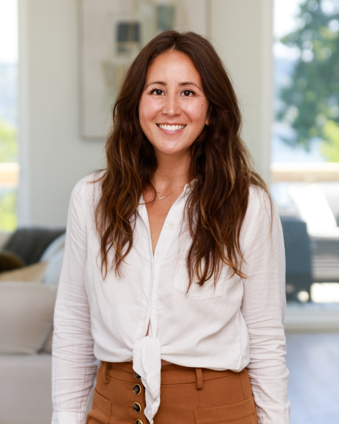 Lindsey Pearsall, West Seattle real estate agent, smiling warmly in a natural light setting—professional, approachable, and ready to help clients buy or sell their home.