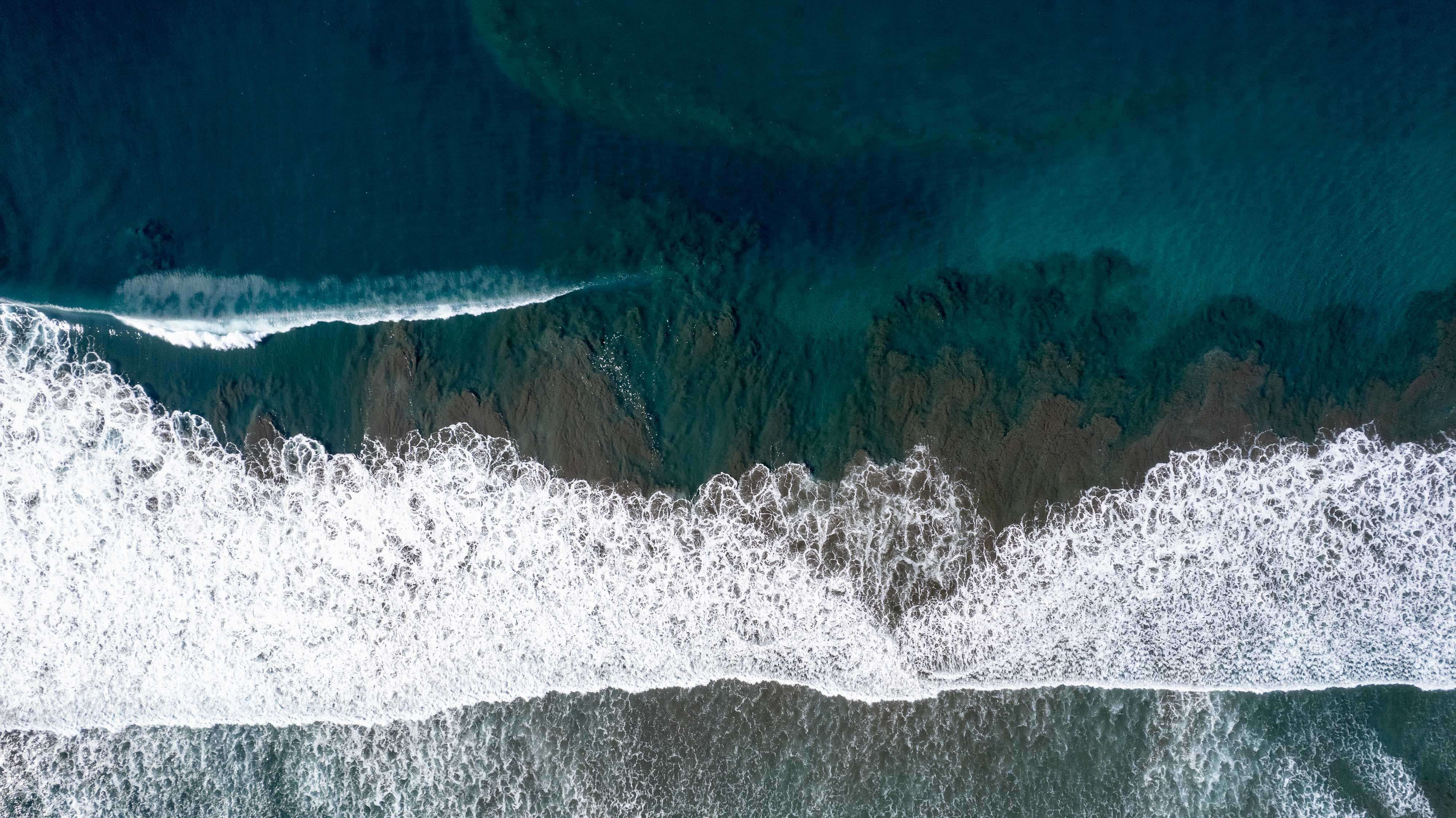 bay with boats in it and town in background