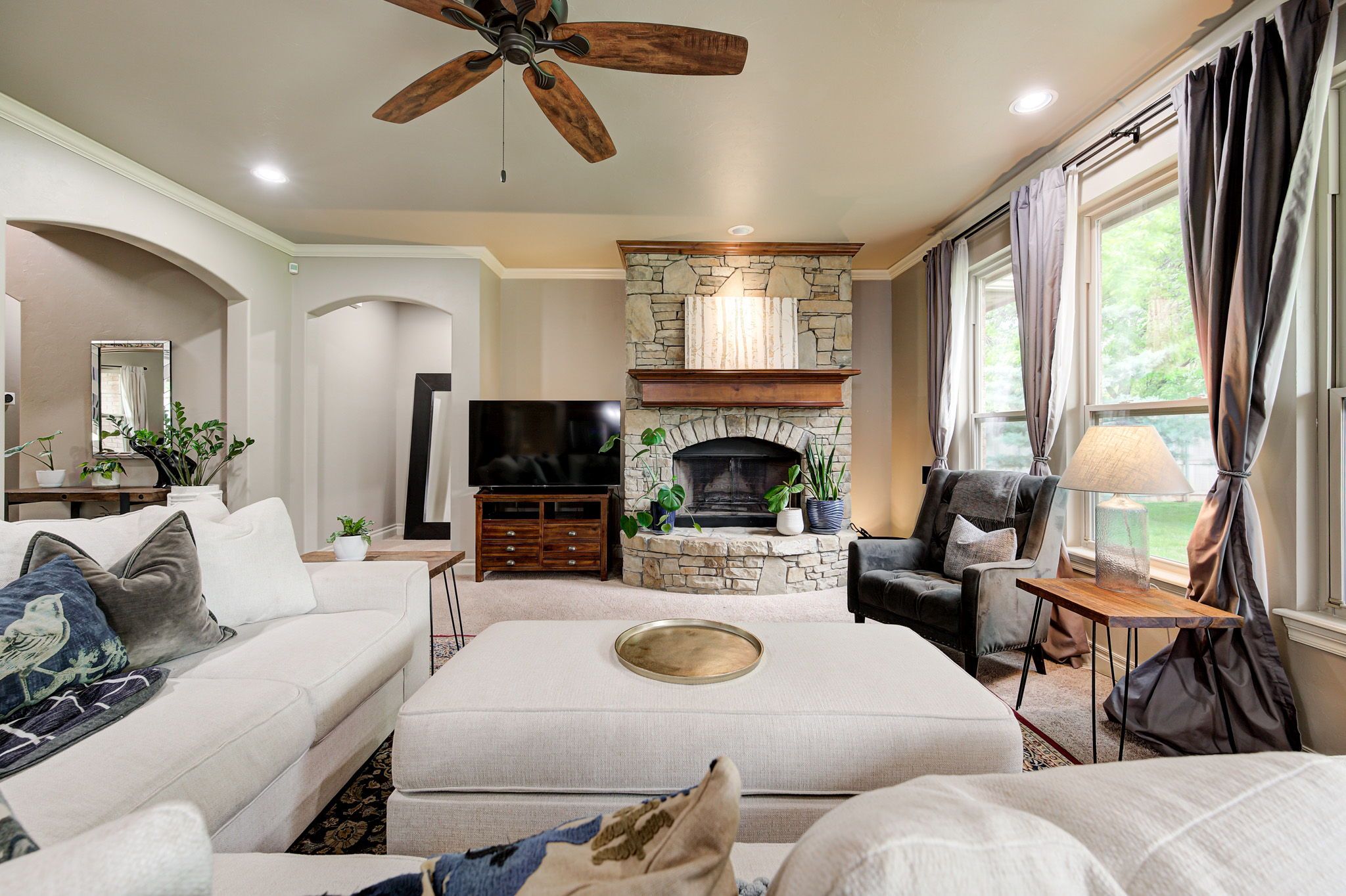 Great room at 10430 Pine Ridge Road in Edmond with views toward the treed backyard