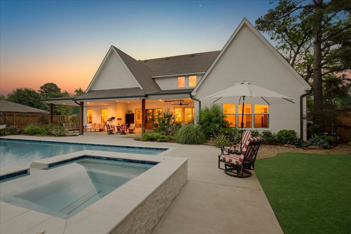 Luxury pool and custom home at twilight at 4311 N Peniel Avenue in Bethany Oklahoma