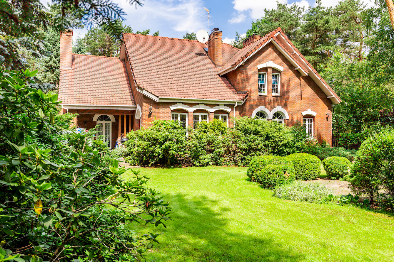 beautiful brick home with lush garden
