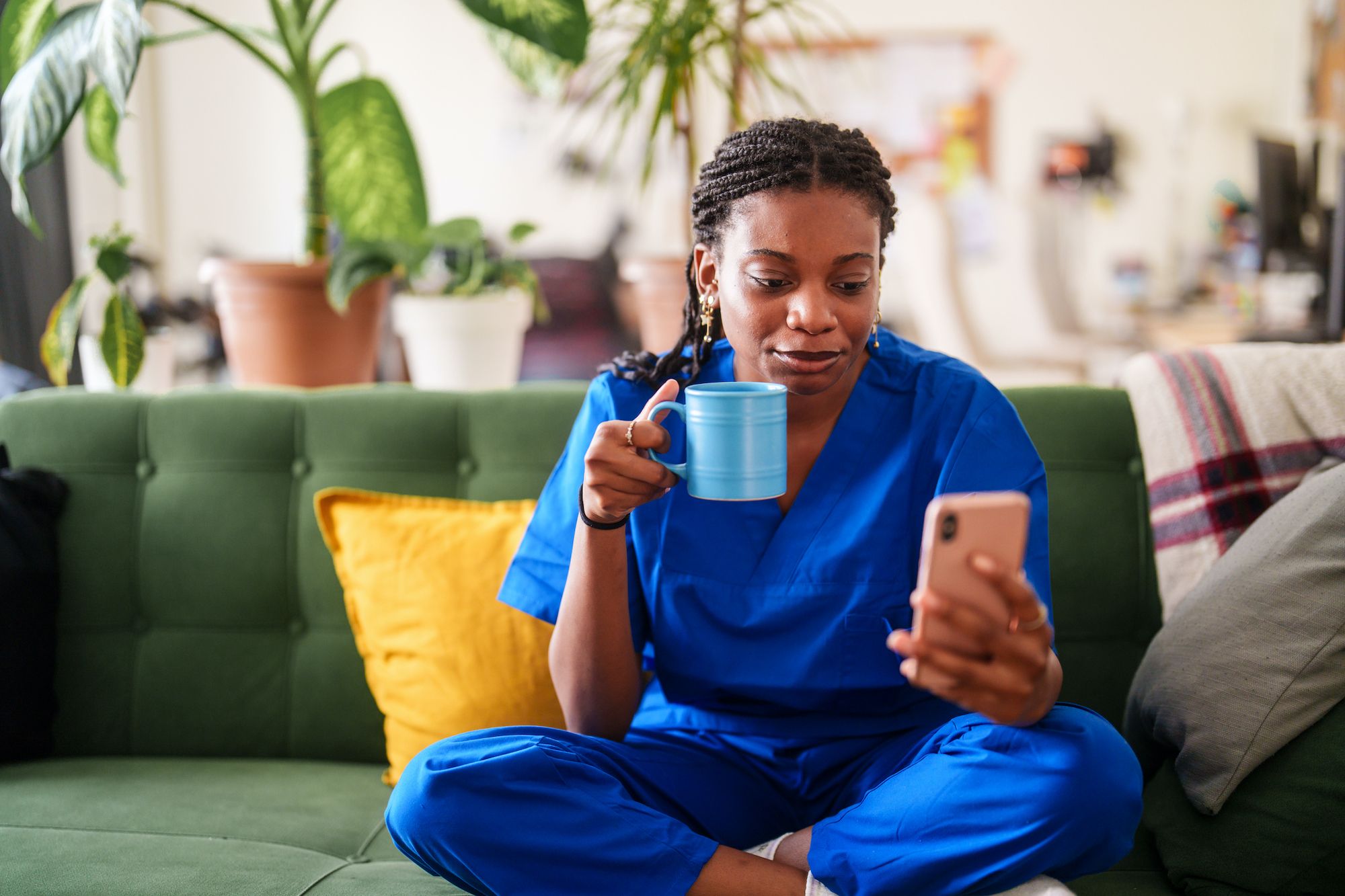 nurse on couch drinking coffee