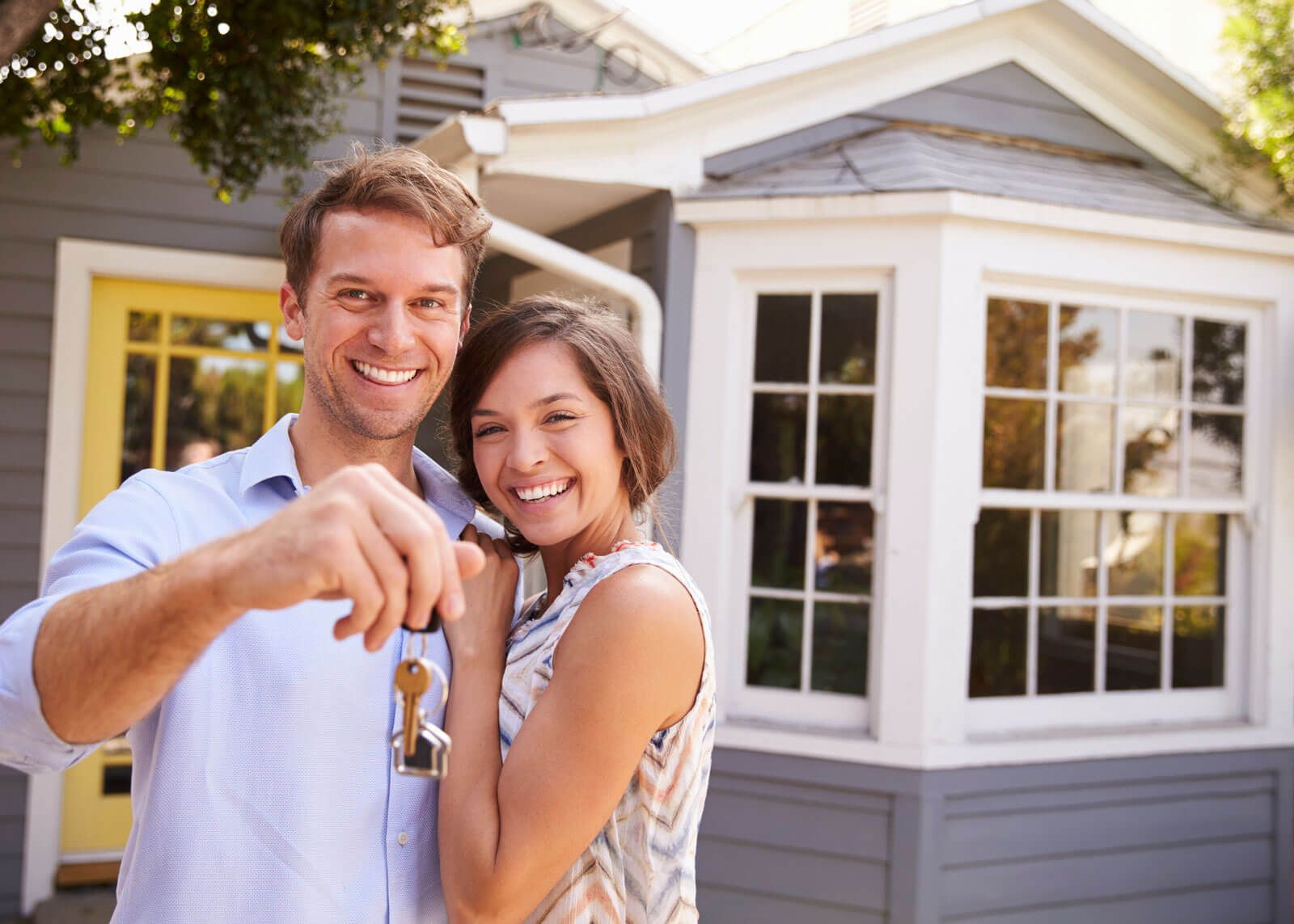 Couple holds up new house keys