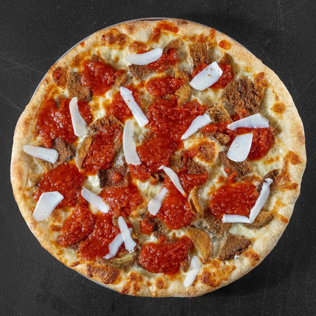 Plate with hamburger, French fries, lettuce, tomato, and onion sandwich with side of French fries on a white table, accompanied by a glass of dark soda, ketchup, and salt and pepper shakers.