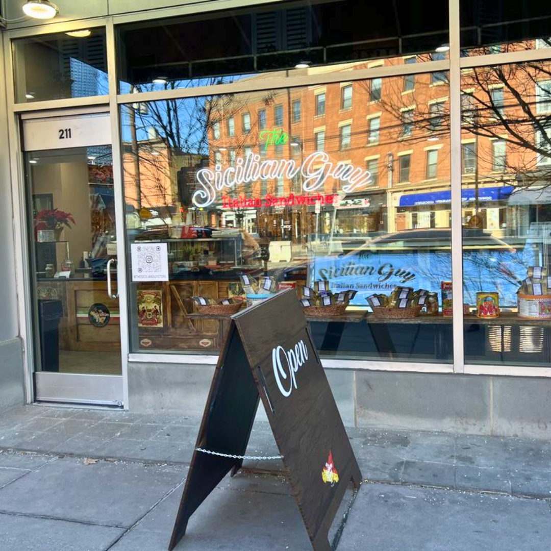 Front view of Sicilian Guy Italian Sandwiches storefront with a black 