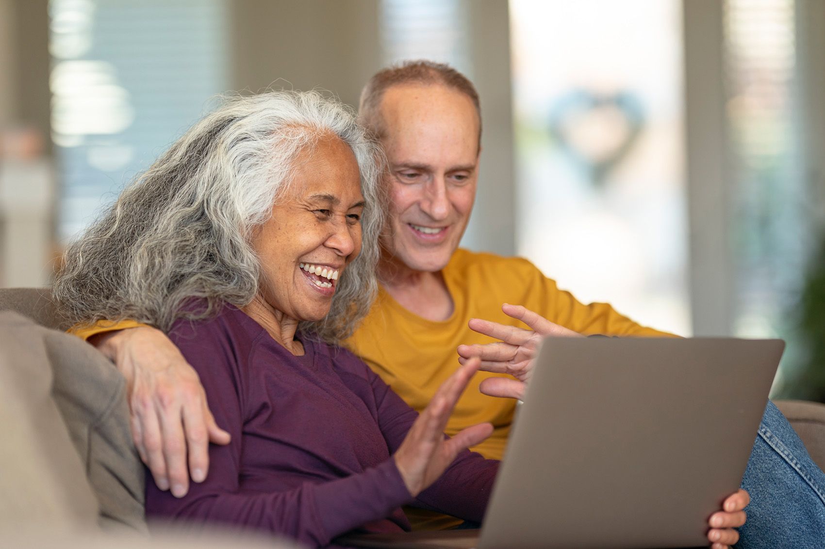 senior couple attending zoom webinar