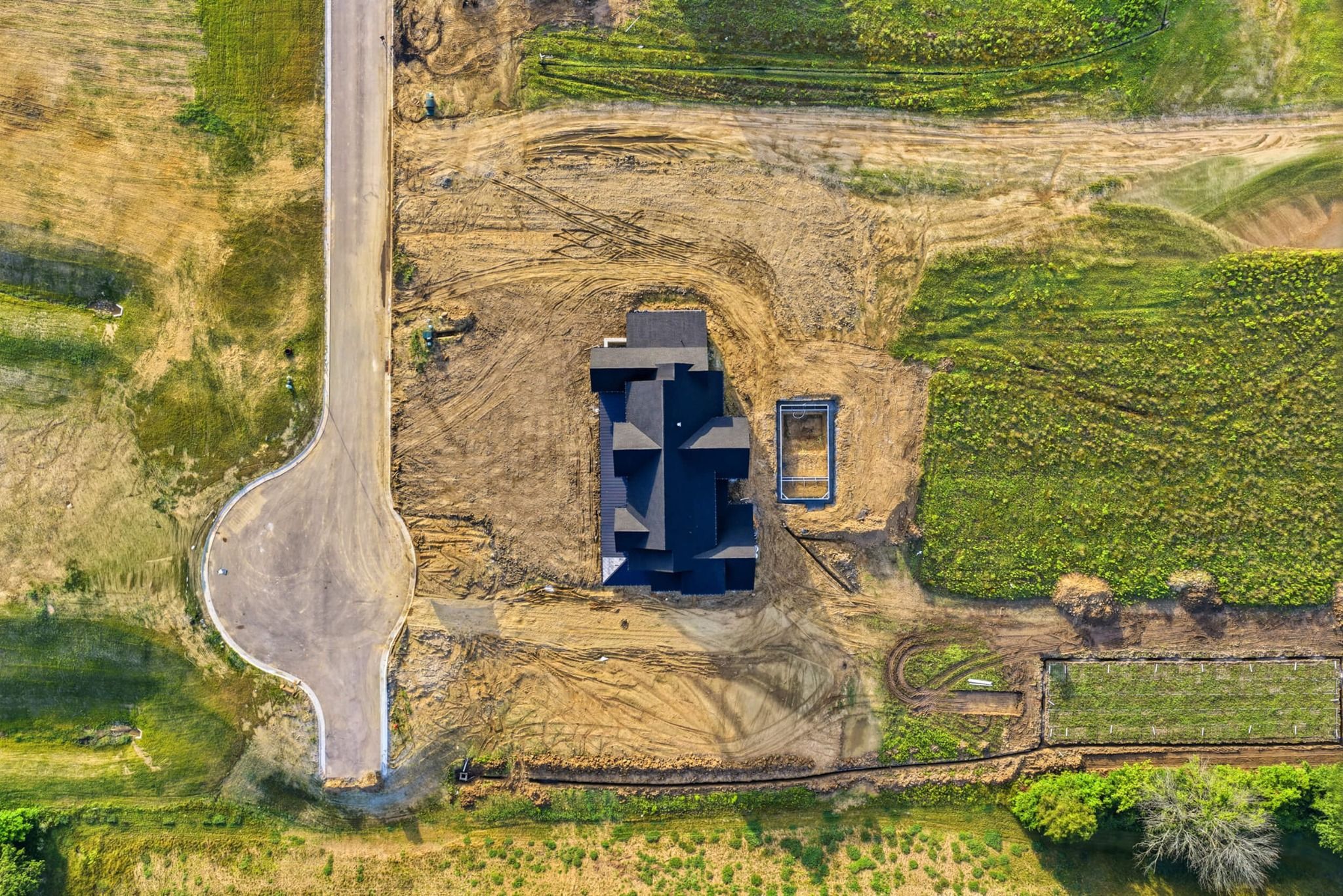 Aerial bird's-eye view of the home and pool excavation on 2.3 acres