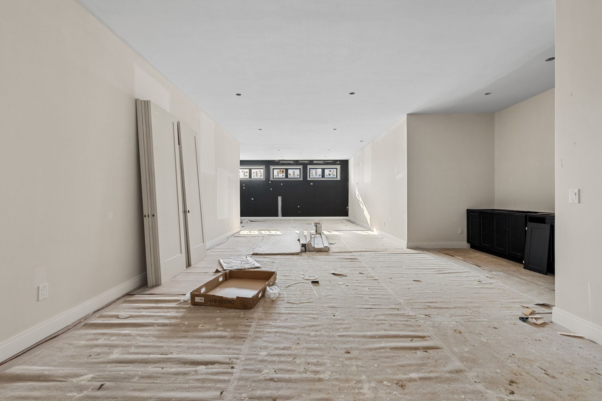 Great Room under construction with vaulted ceiling and window wall