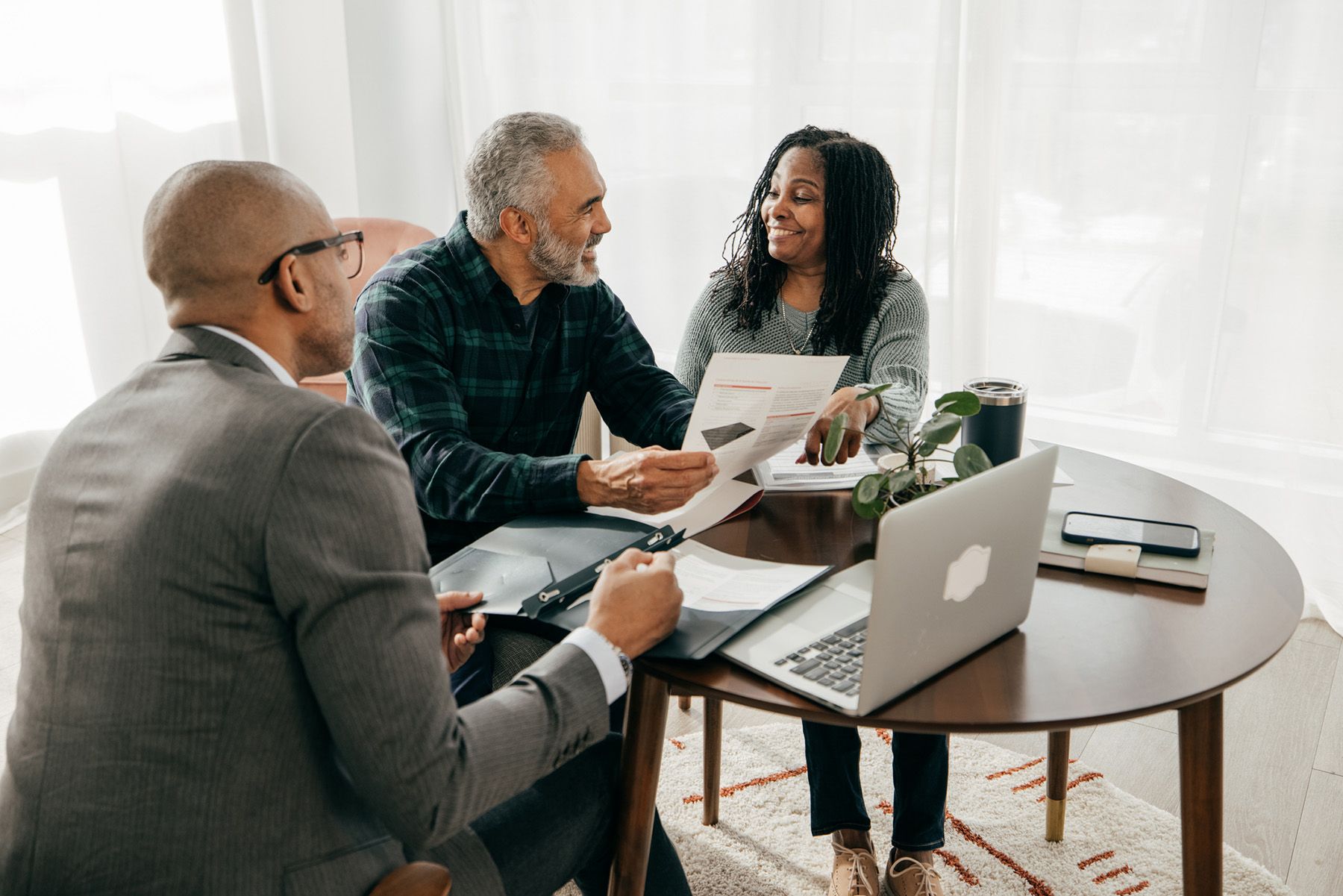 Couple making plans with real estate agent about their home