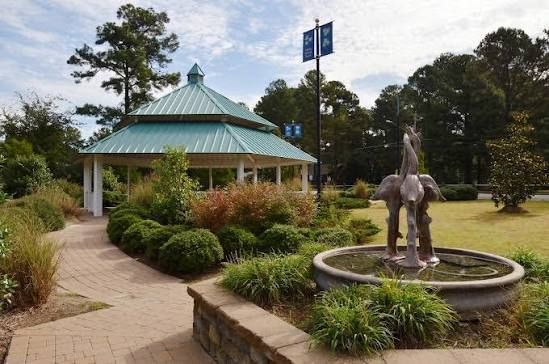 Rolesville NC community park featuring landscaped walkways, gazebo, fountain, and gathering spaces.