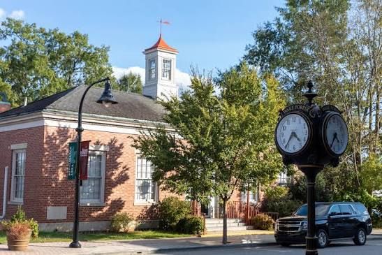 Historic downtown Wake Forest featuring the iconic town clock, walkable streets, mature trees, and charming small-town architecture.