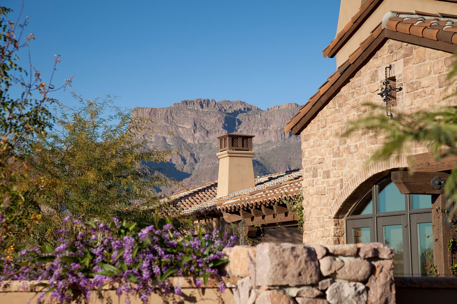woman with glasses does paperwork by laptop