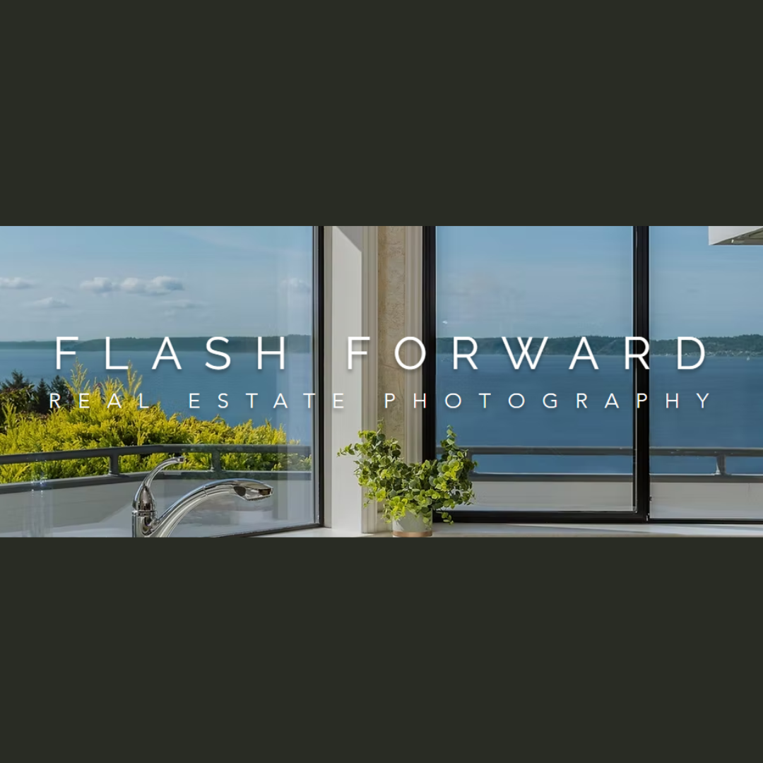 Modern kitchen window overlooking a lake with a potted plant and a view of greenery and blue sky