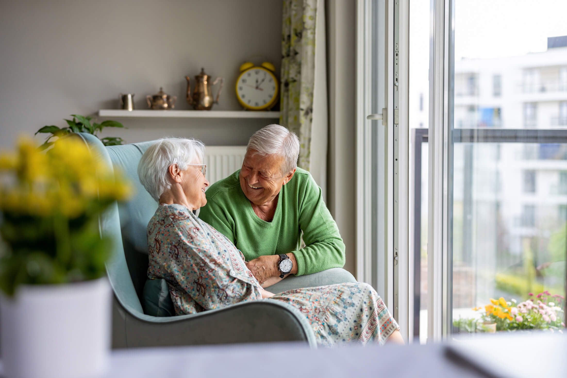 senior couple looks out window