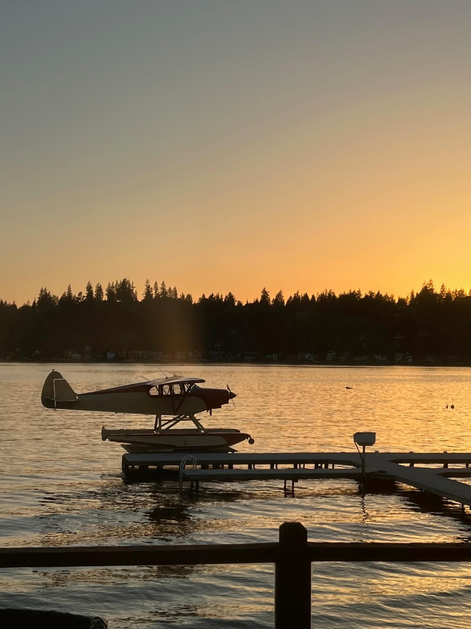 airplane on lake at sunset