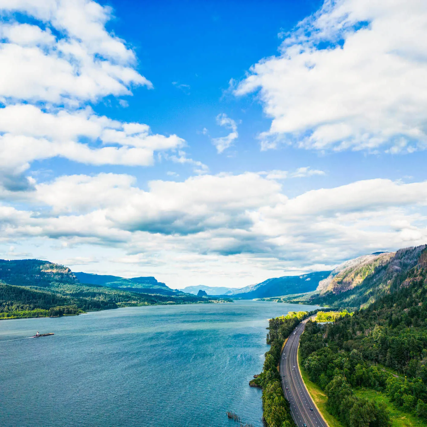Columbia River and surrounding mountains near Vancouver, Washington, with a scenic highway along the river.