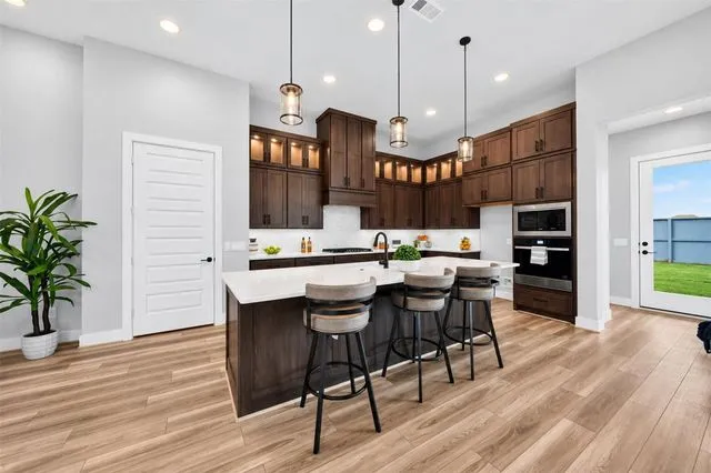 Kitchen with a central island and wood cabinetry