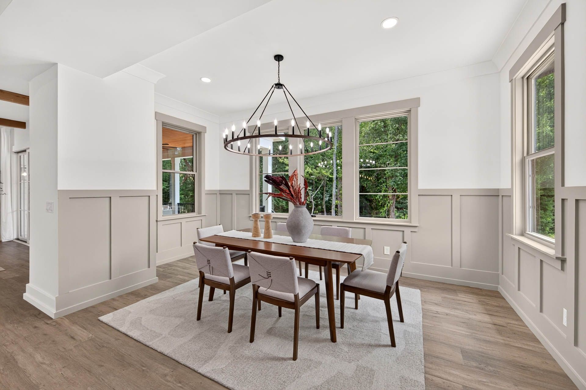 Wainscoted dining room with round chandelier