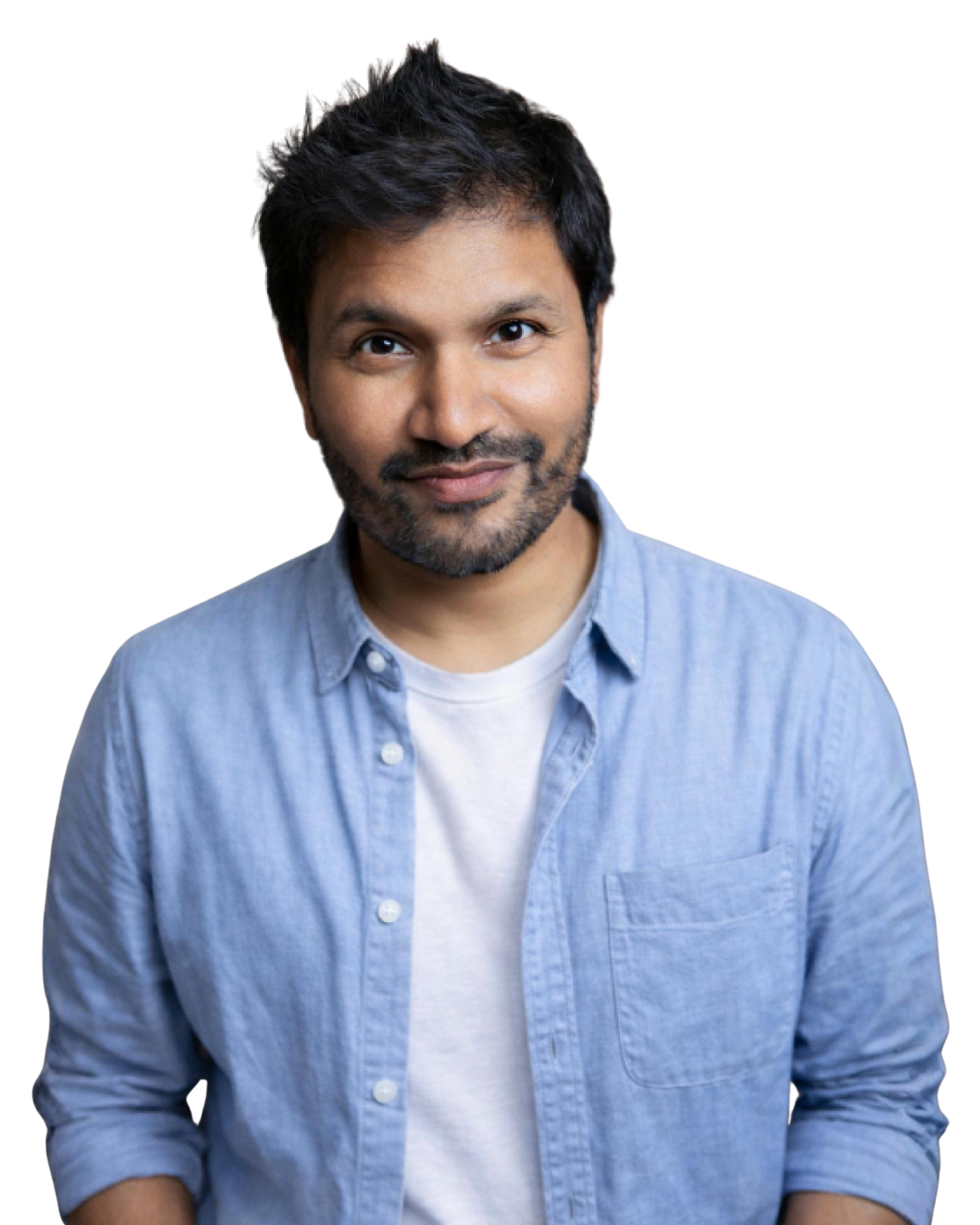 Professional headshot of a man with short dark hair, a beard, wearing a blue checkered vest over a light blue dress shirt, smiling confidently against a blurred outdoor background