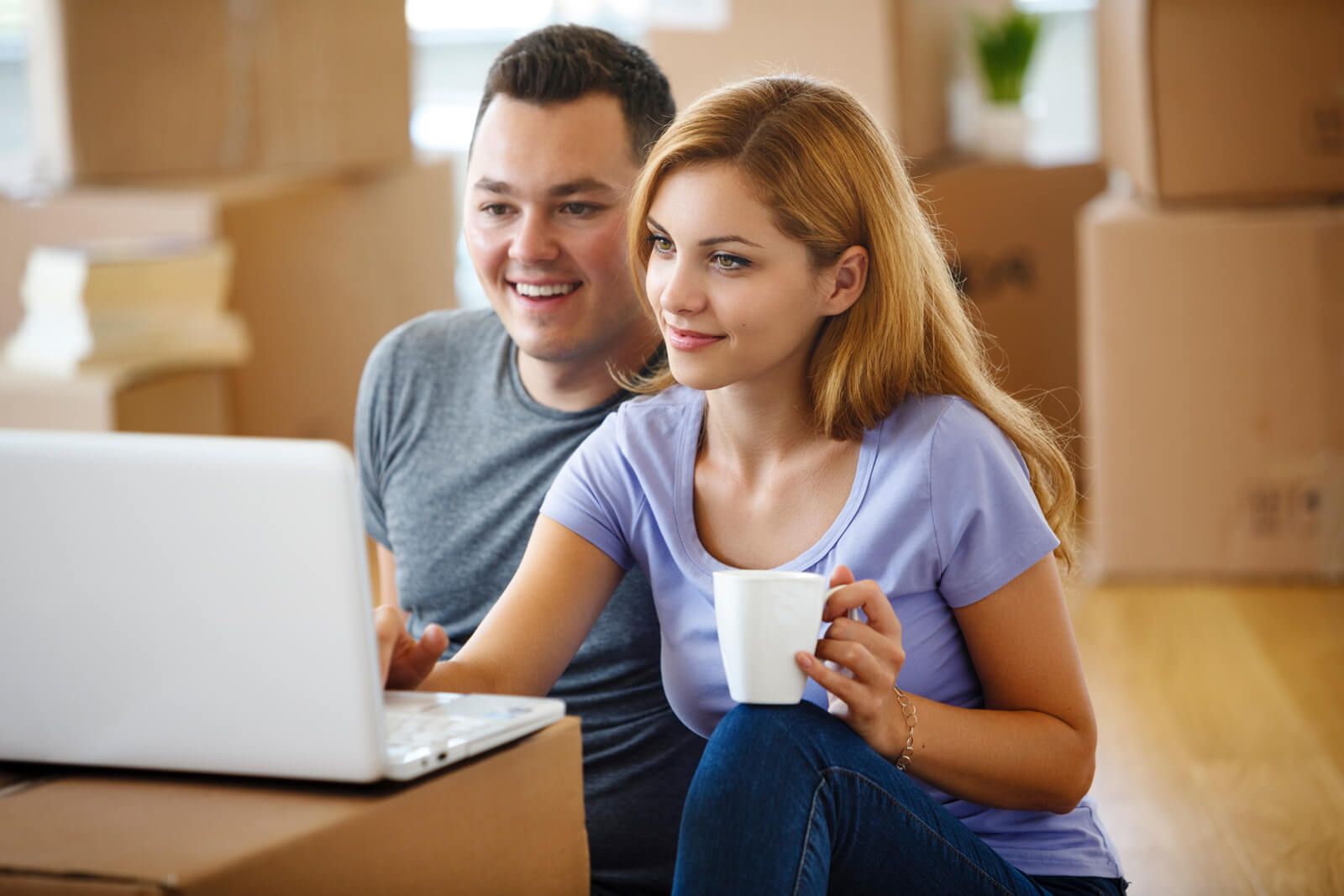 woman with glasses does paperwork by laptop