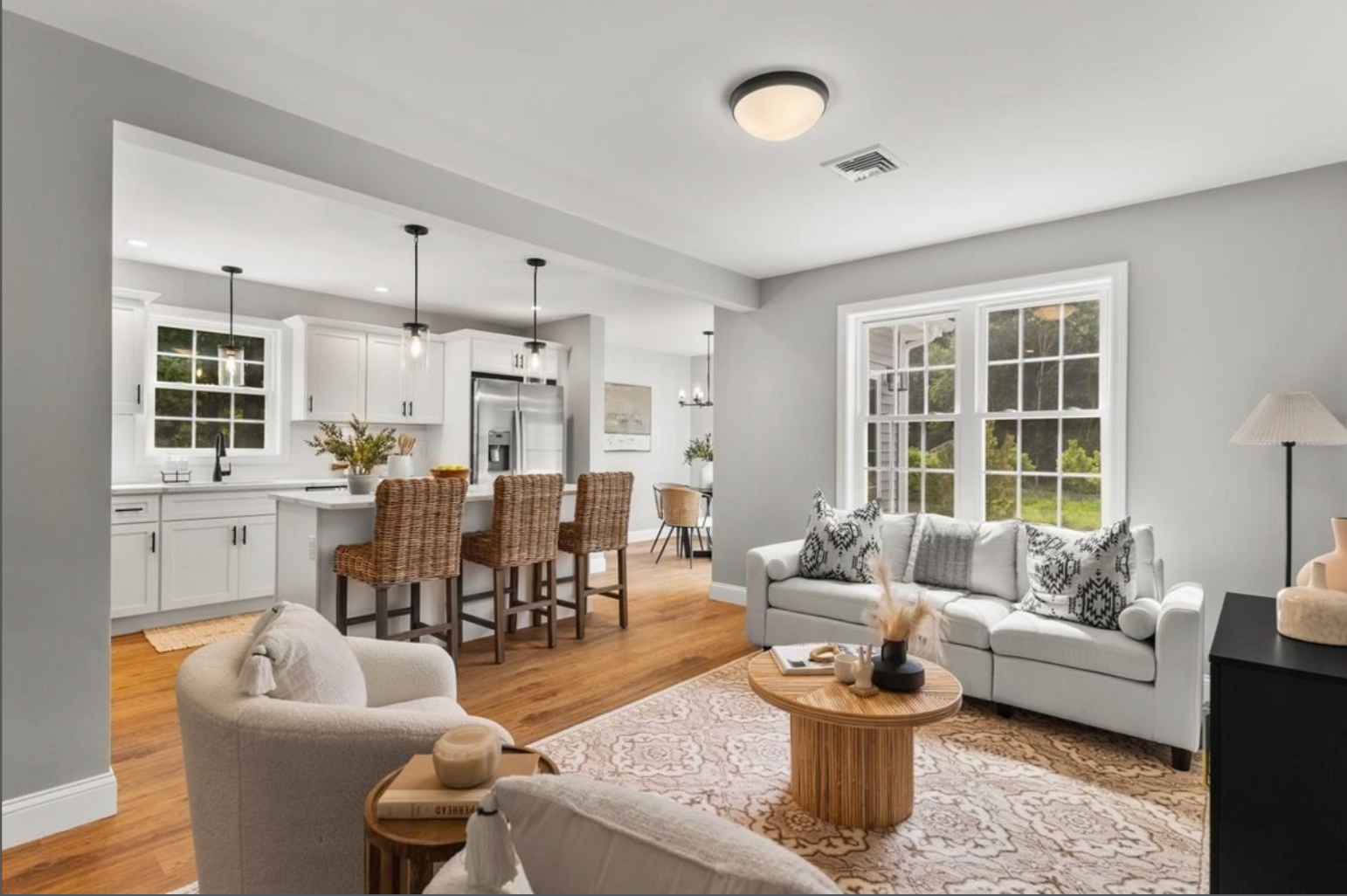 Open-concept living room and kitchen with island seating in a new-construction townhouse on Wales Street, Taunton, MA