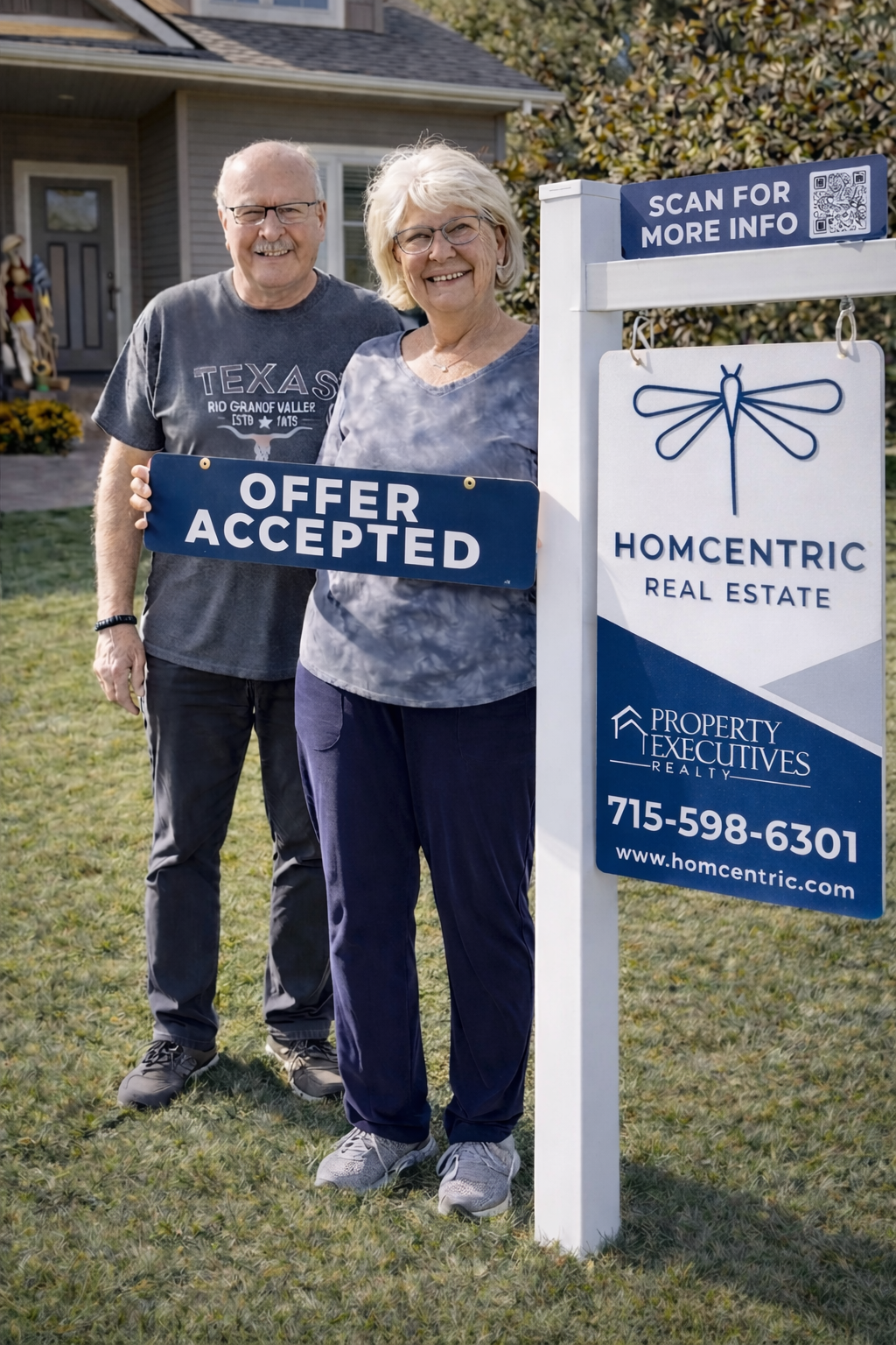 Happy sellers holding an Offer Accepted sign with Homcentric Real Estate in the Chippewa Valley