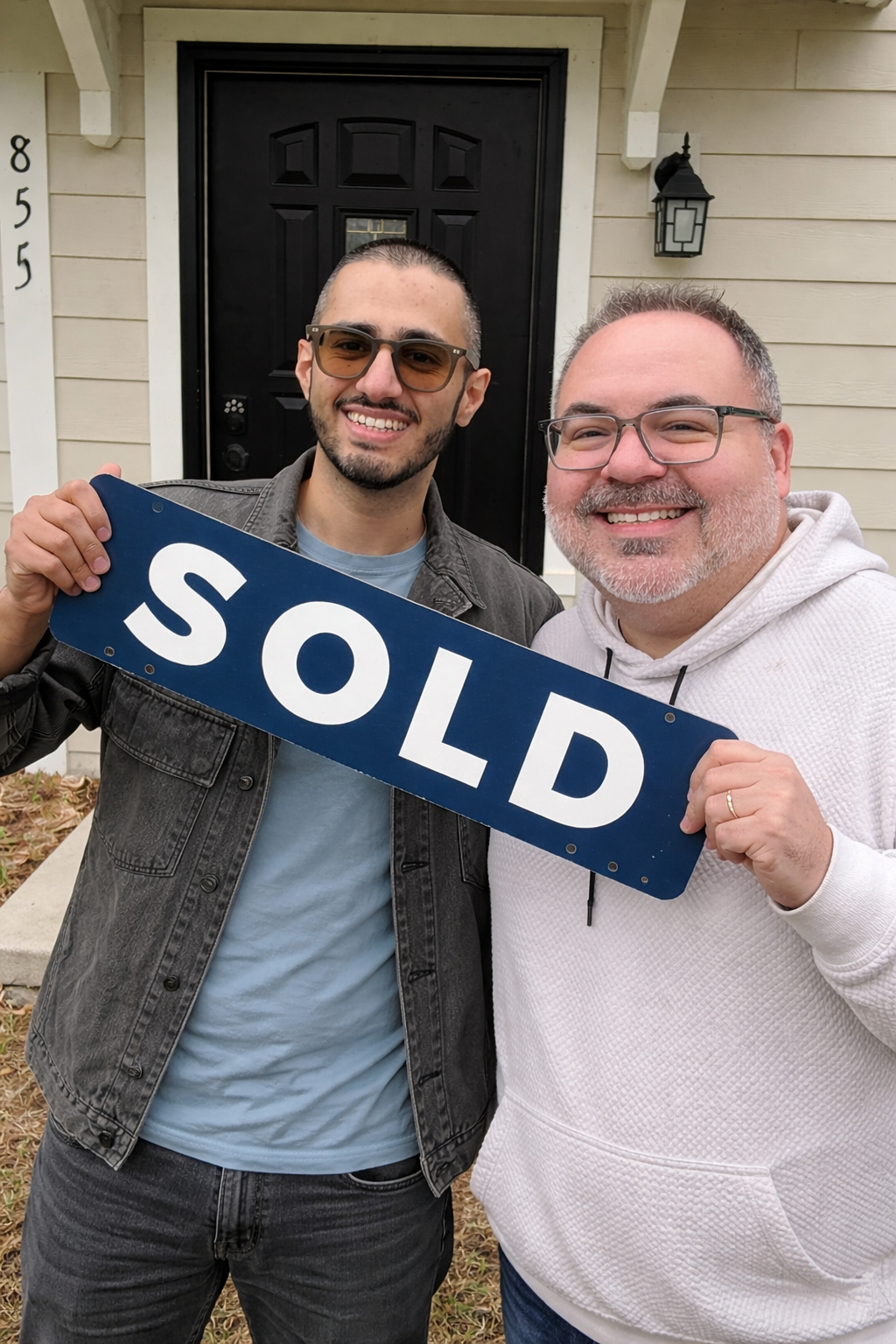 Brad Bemowski, Eau Claire Realtor, with a happy buyer holding a SOLD sign in the Chippewa Valley