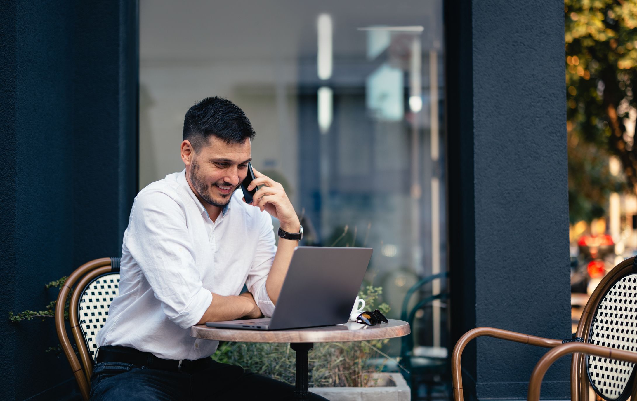 woman with glasses does paperwork by laptop