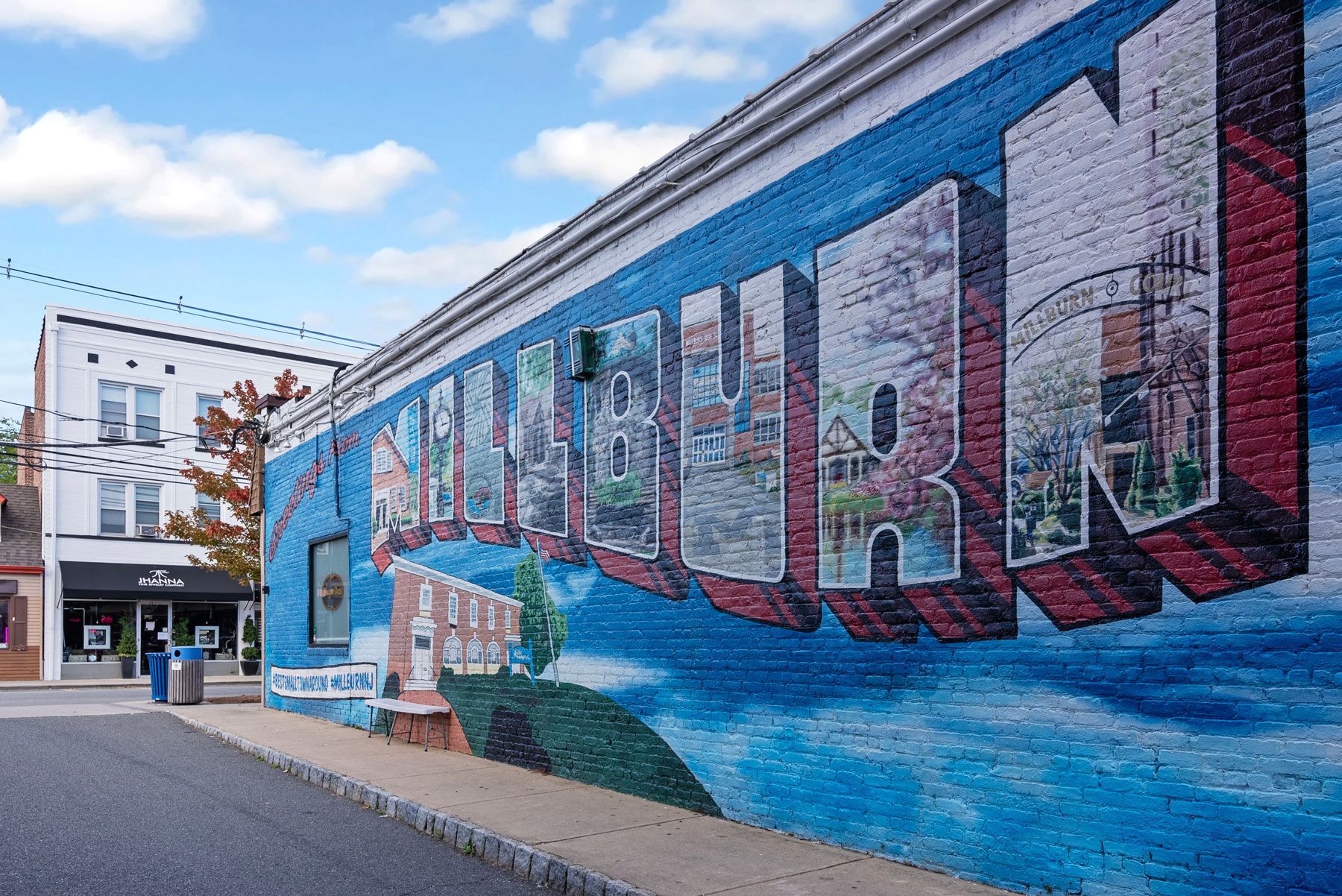 Colorful mural on brick wall featuring the words 