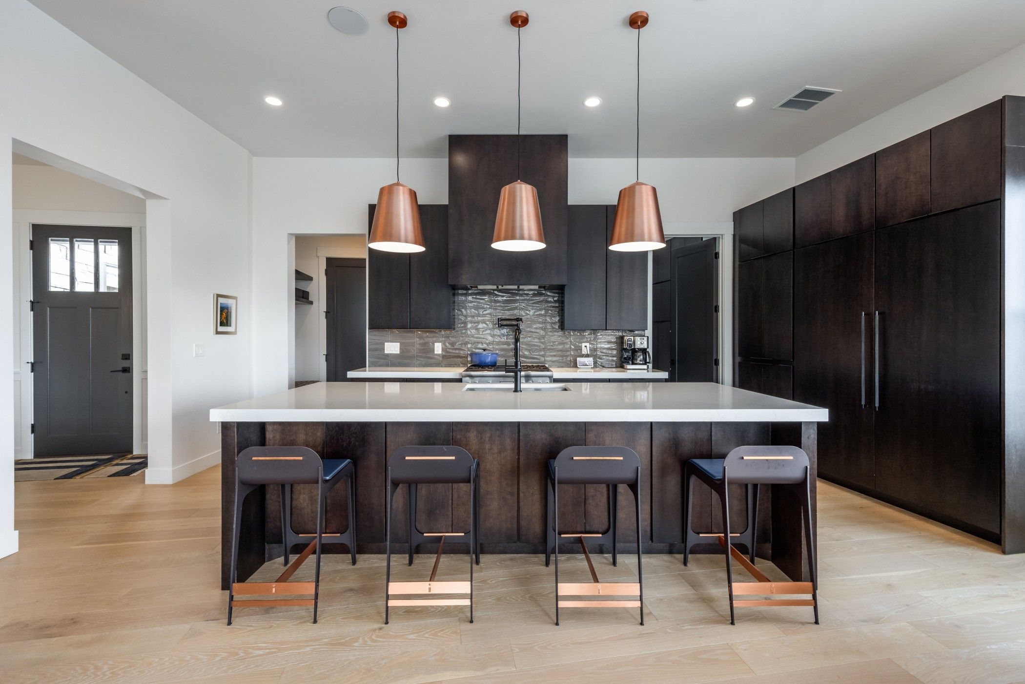 woman with glasses does paperwork by laptop