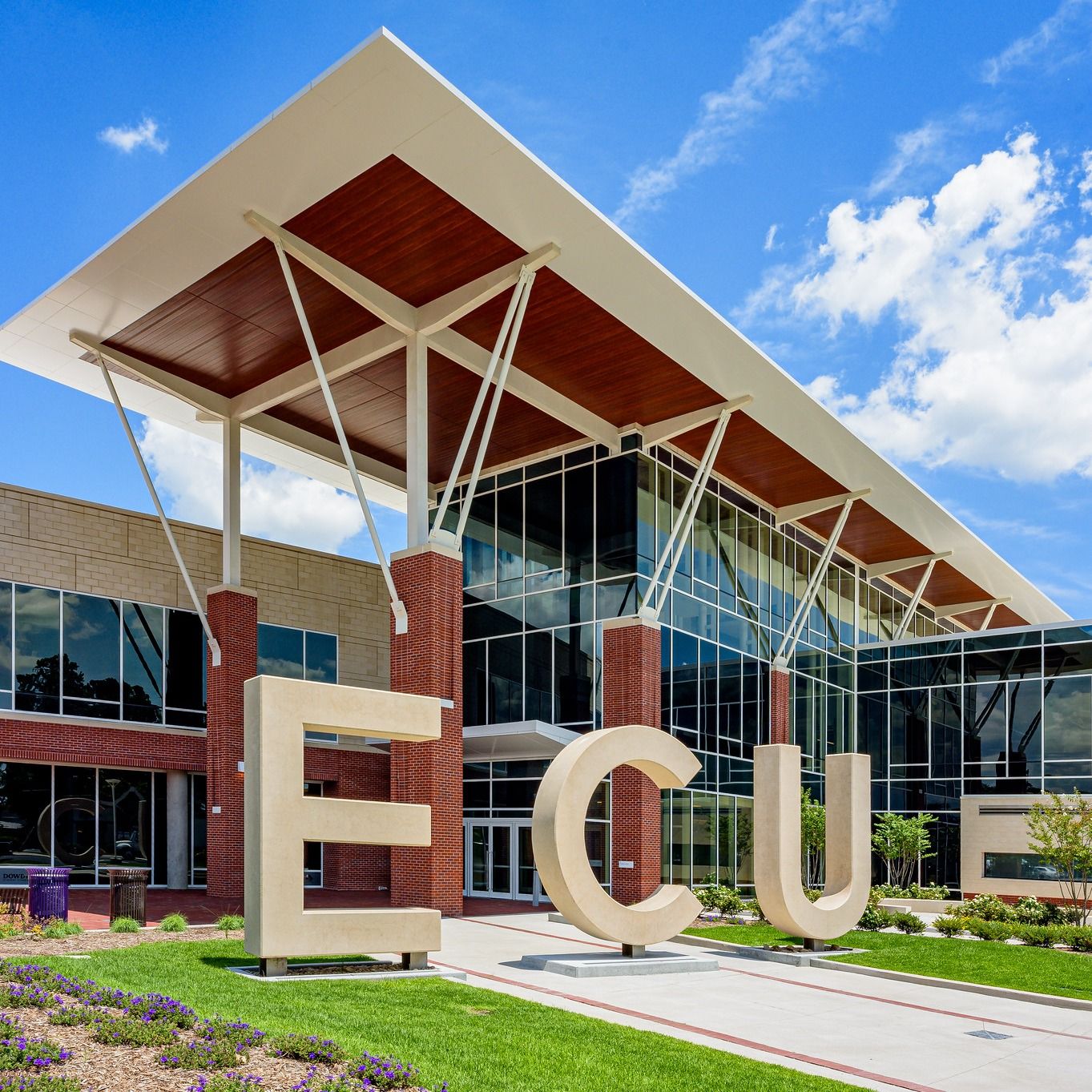 Virtual tour of a modern, spacious living room with large windows, contemporary furniture, and a scenic outdoor view, powered by Matterport.