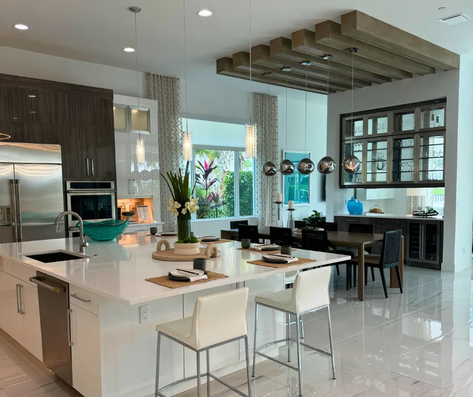 Open kitchen and dining area inside a Coral Isles at Avenir home in Palm Beach Gardens