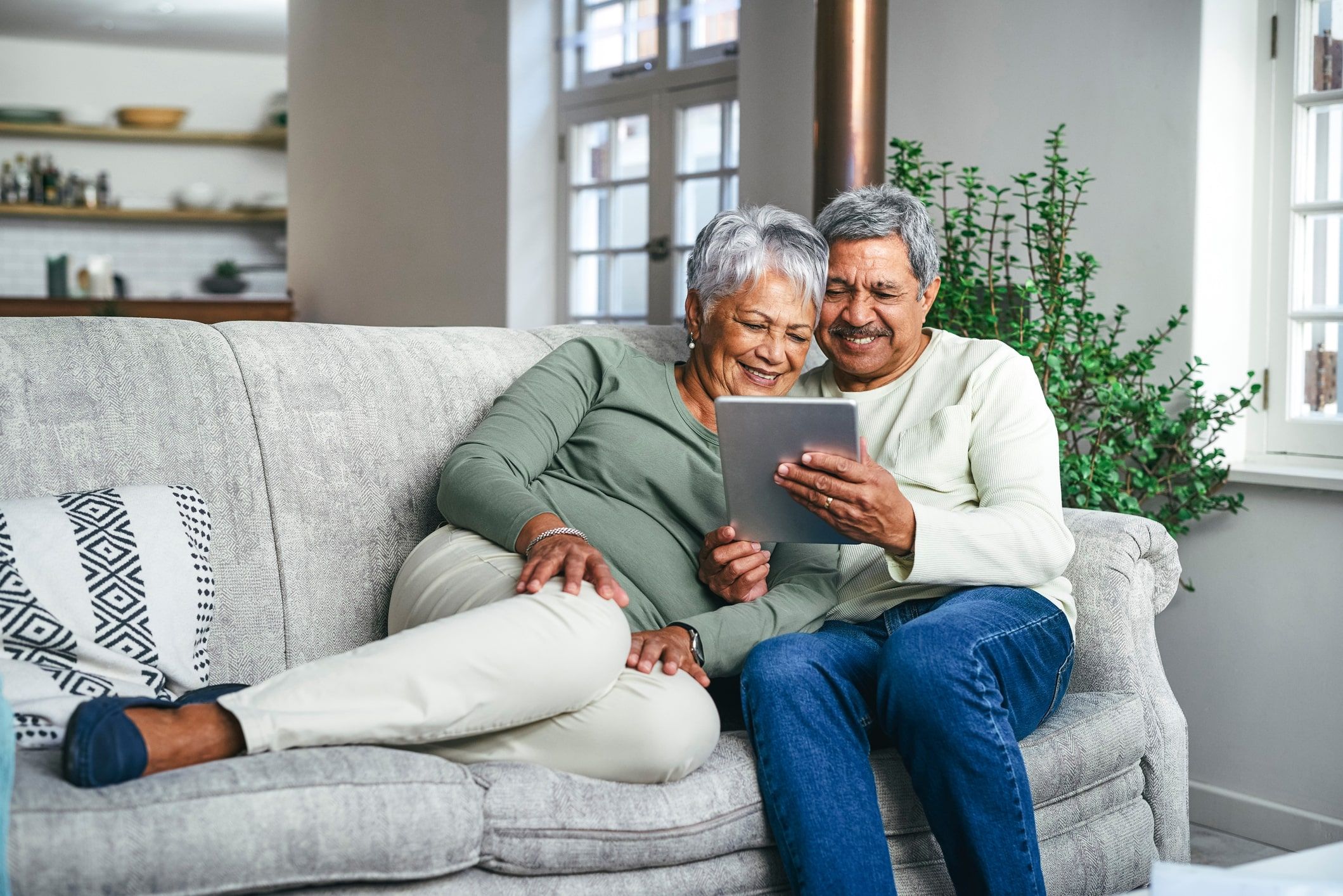 Couple cuddles on couch