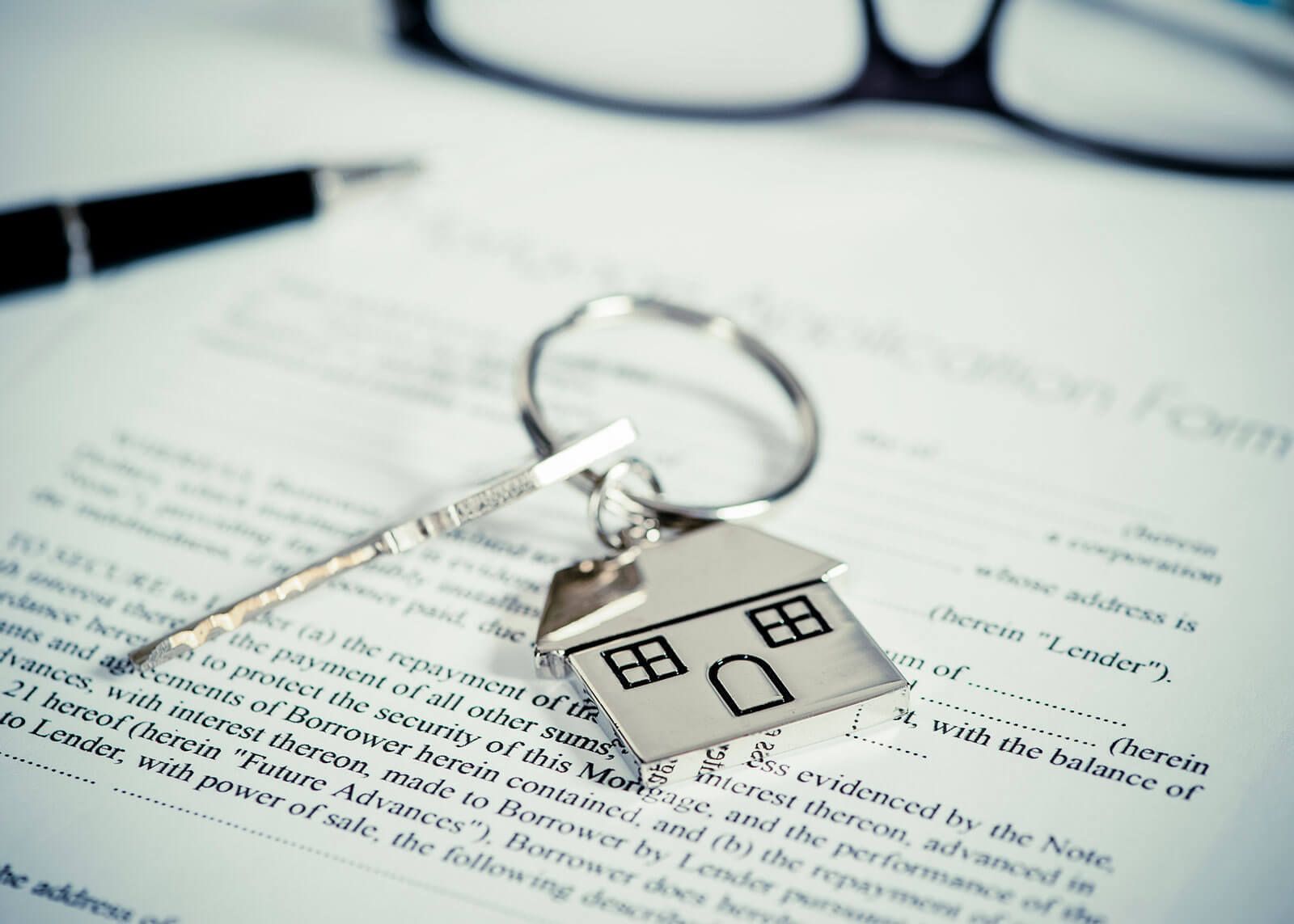 woman with glasses does paperwork by laptop