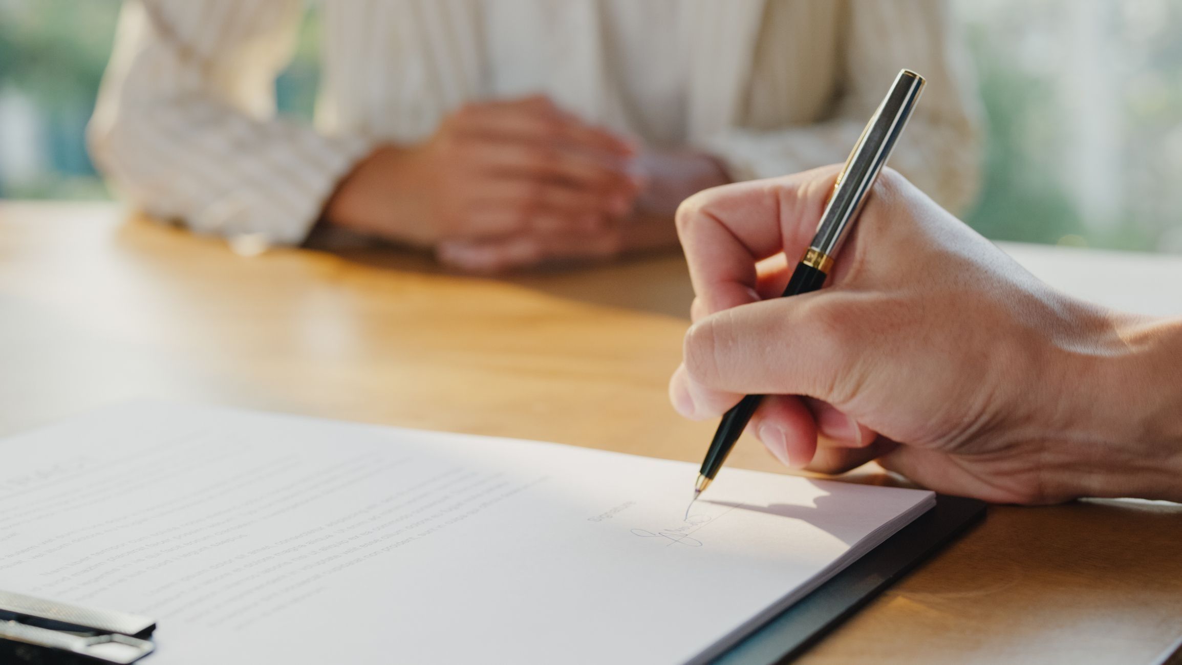 woman with glasses does paperwork by laptop