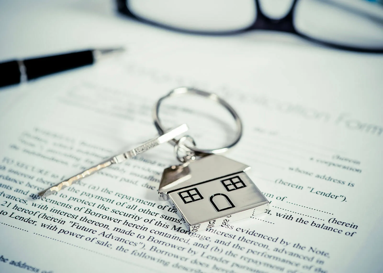 woman with glasses does paperwork by laptop