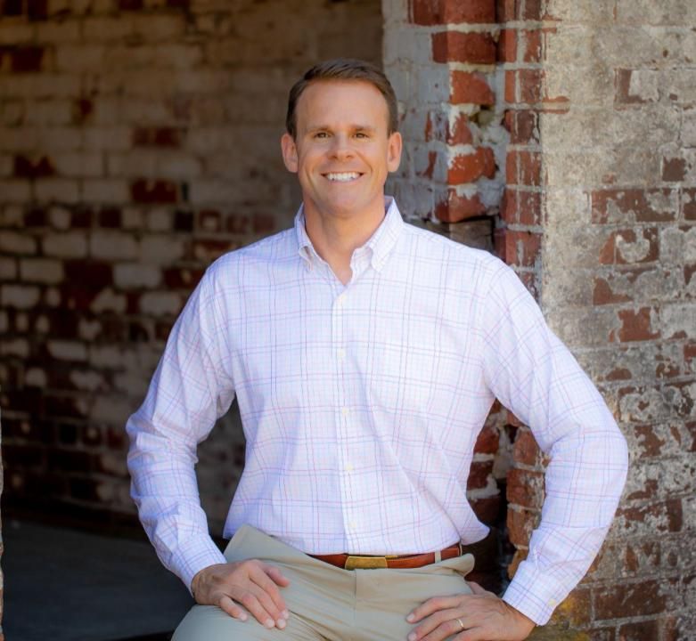 Photo of Kenny Bradberry standing outside with collared polo shirt. 