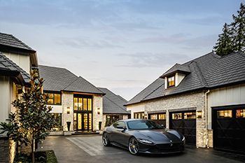 Person holding a drone with a sunset or sunrise over the ocean in the background