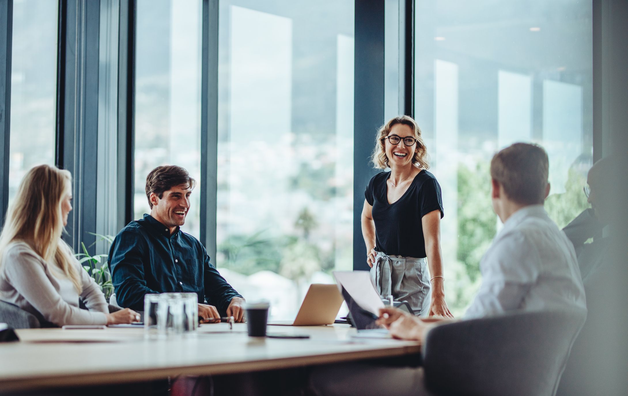 Professional real estate team collaborating together in a bright modern office.