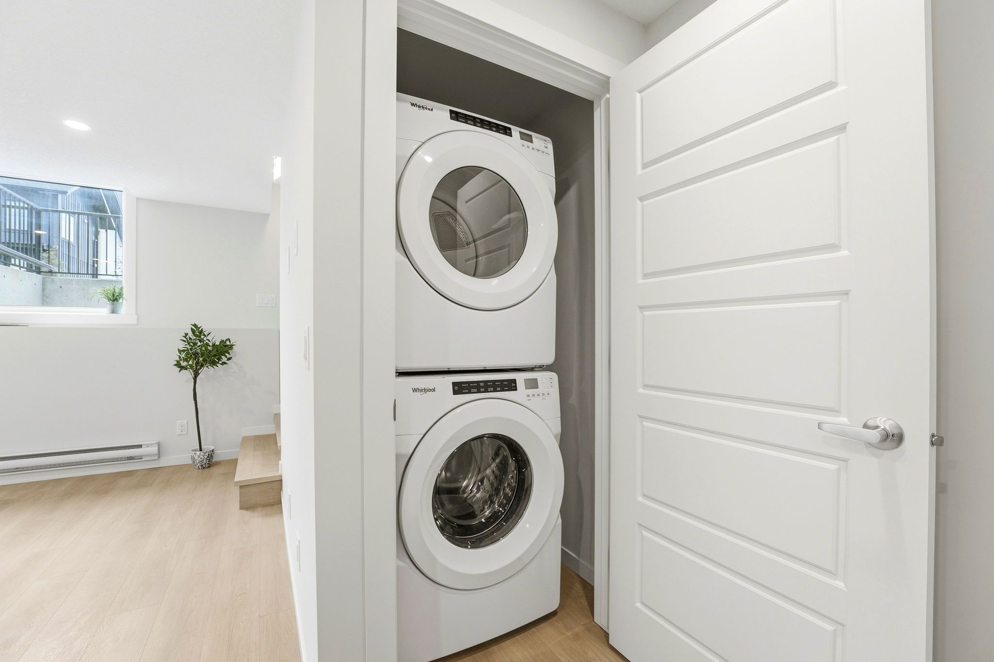 In-suite stacked washer and dryer in the identical neighbouring Braeburn unit at ZEN Livingston