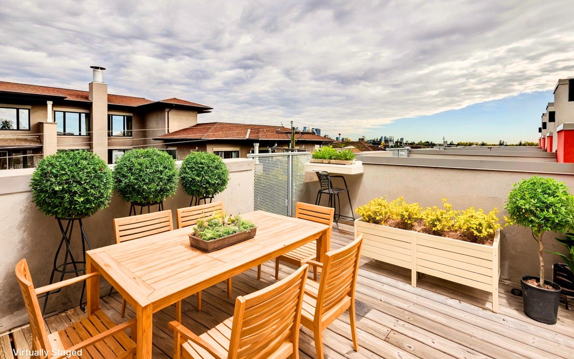 Private rooftop patio at a Marda Loop Calgary townhome with outdoor dining space and city views