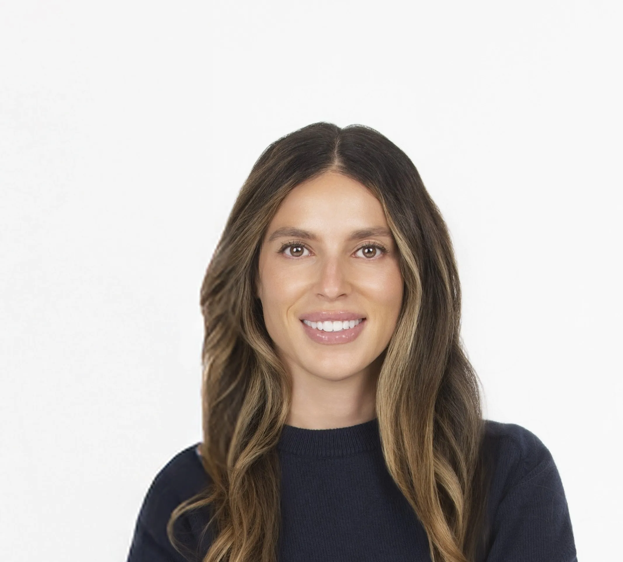 Portrait of a smiling woman with long dark hair wearing a black top, against a plain white background.