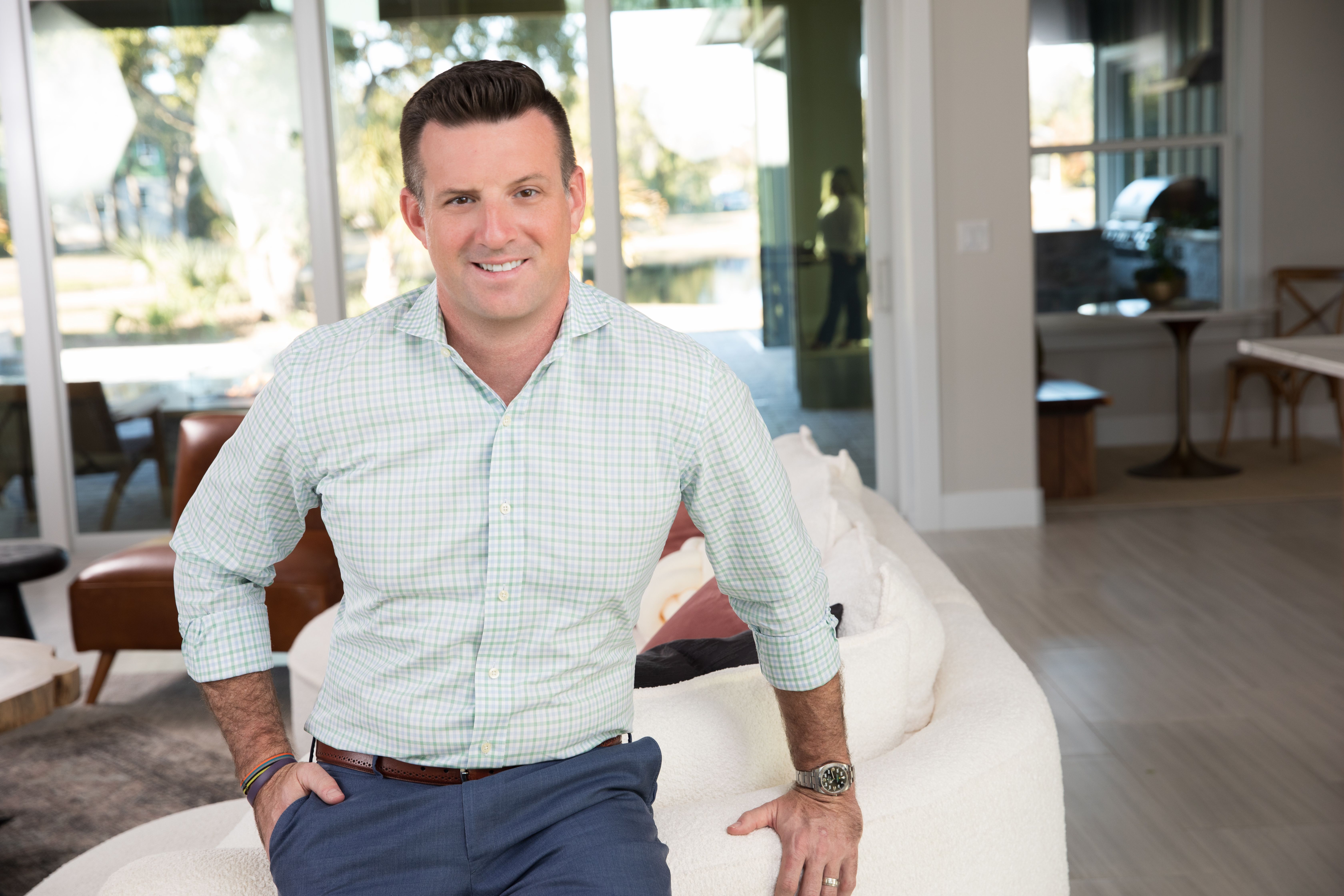 Professional businessman in gray suit smiling in a portrait image